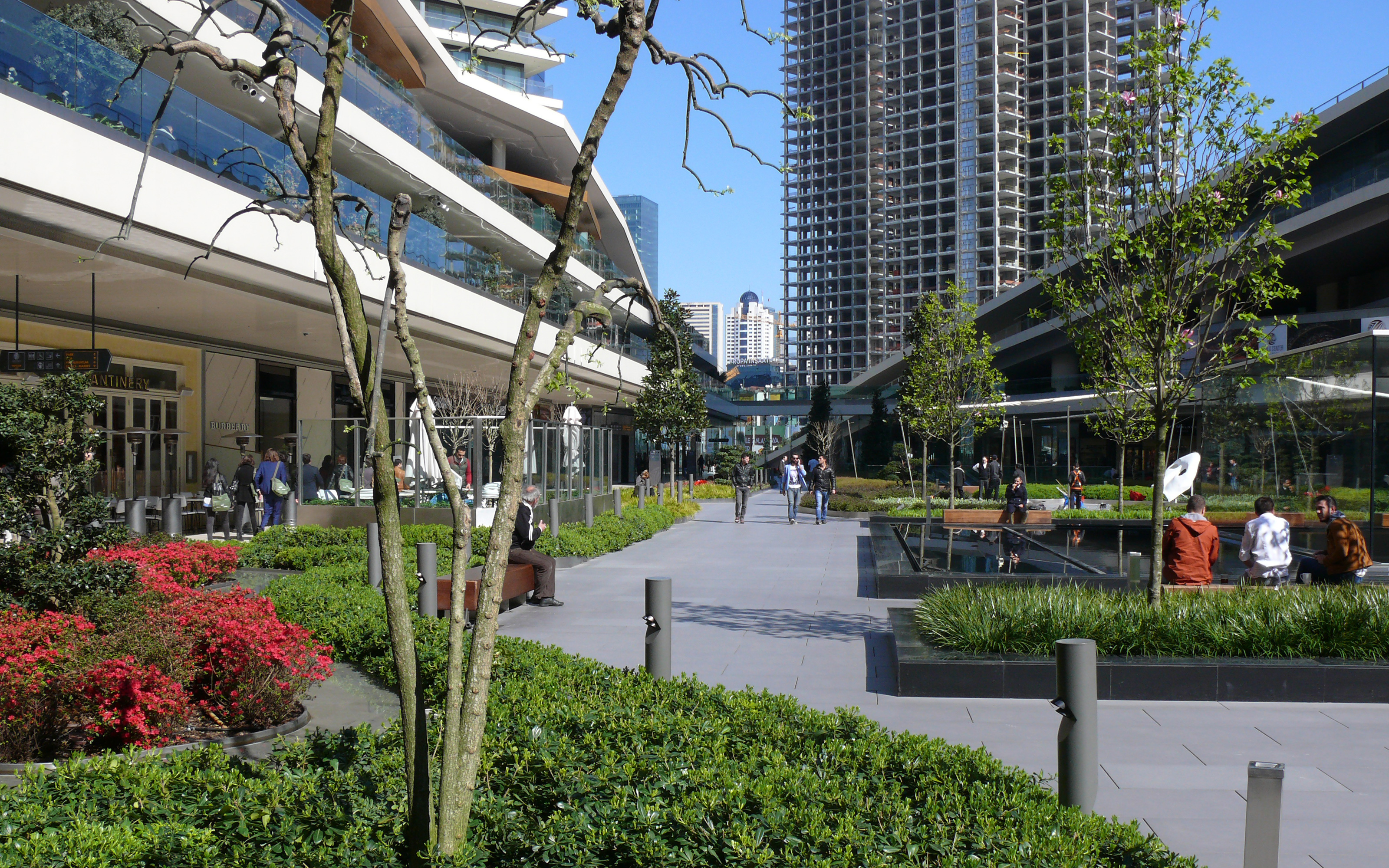 Seats and water features entice people to linger. Planted beds, small trees and seats
